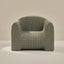 Plush armchair with grid pattern on a beige background