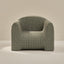 Plush armchair with grid pattern on a beige background