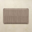 Rectangular mat with horizontal striped pattern on a beige background