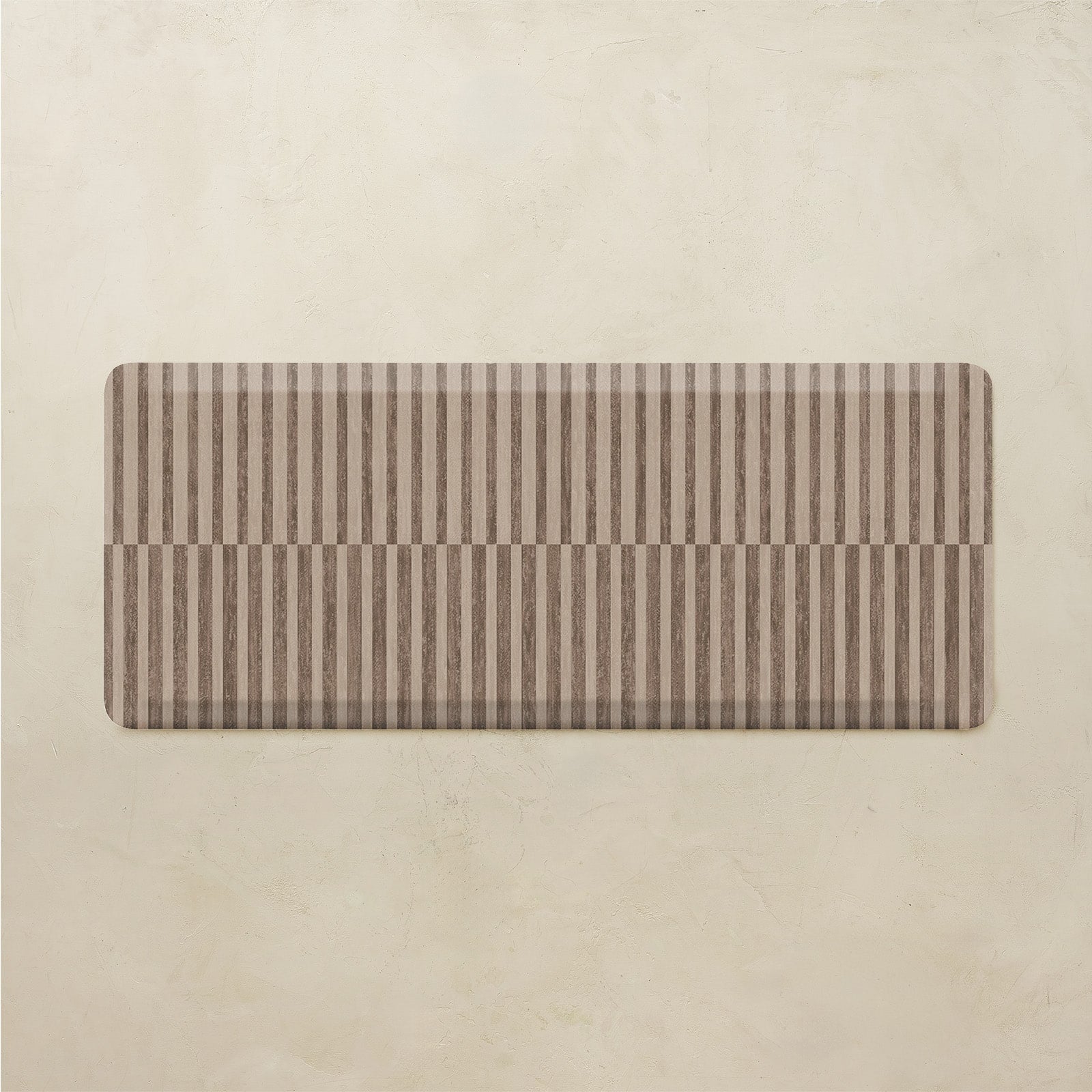 Rectangular kitchen mat with brown and beige stripes on a beige background