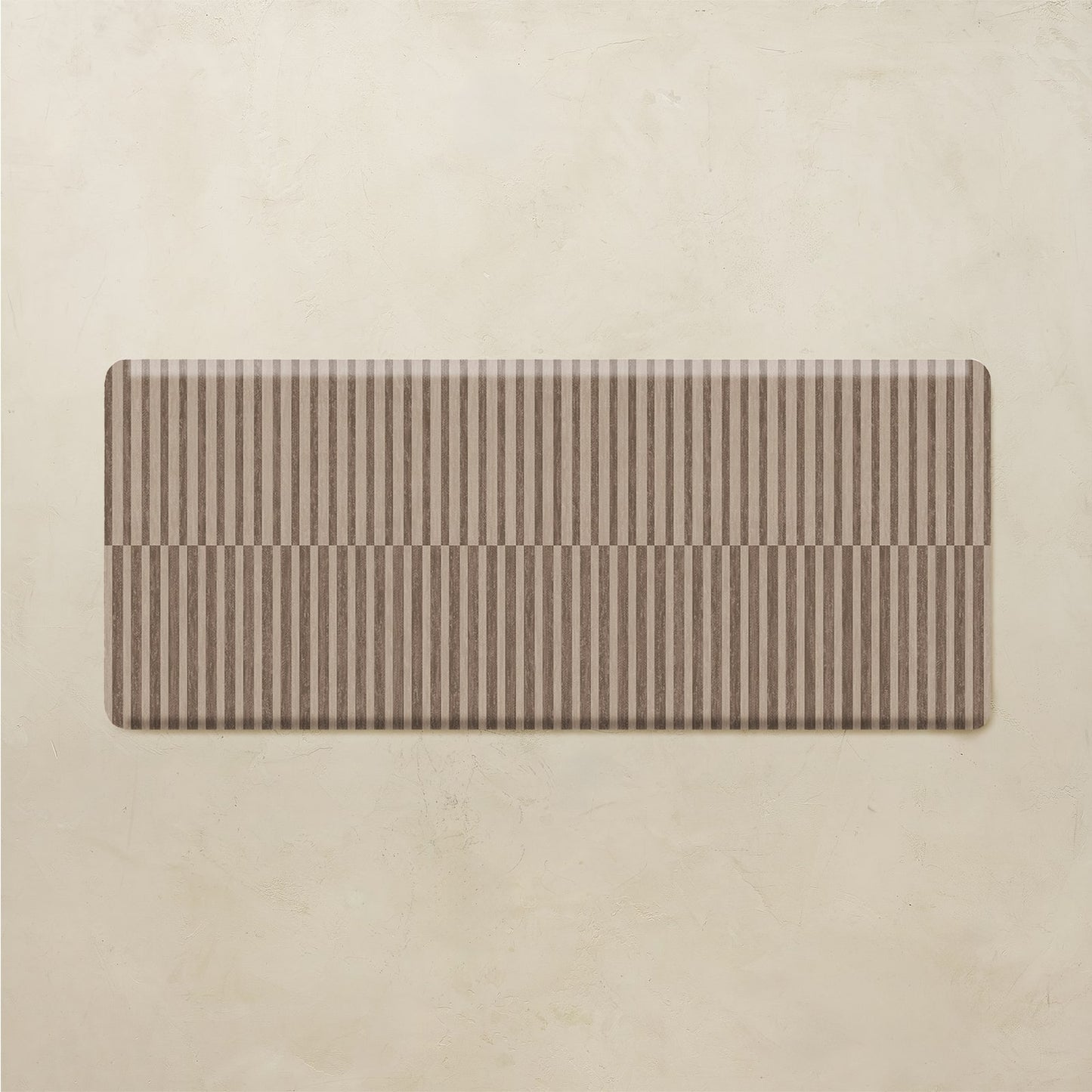 rectangular brown stripe kitchen mat on a beige background