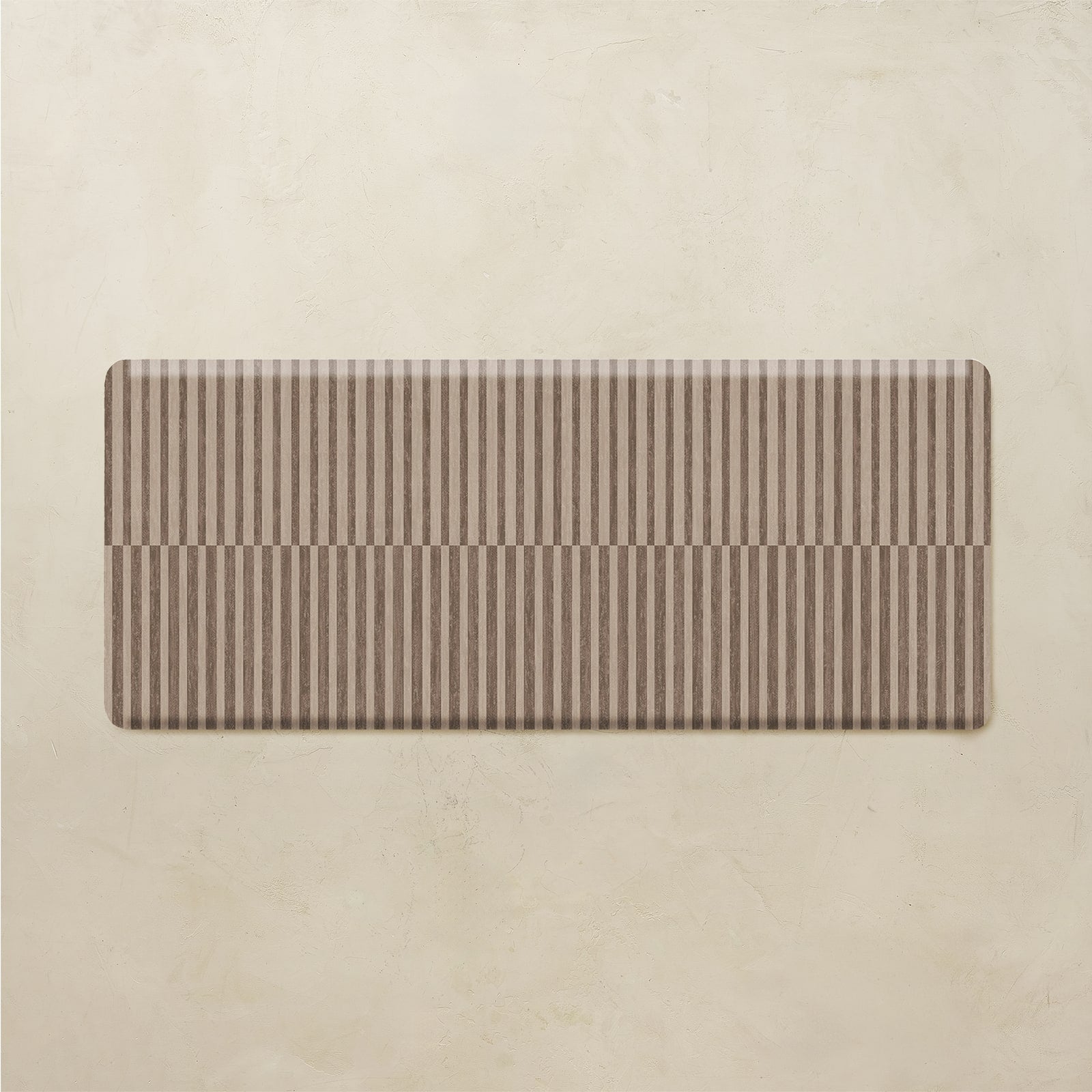 rectangular brown stripe kitchen mat on a beige background