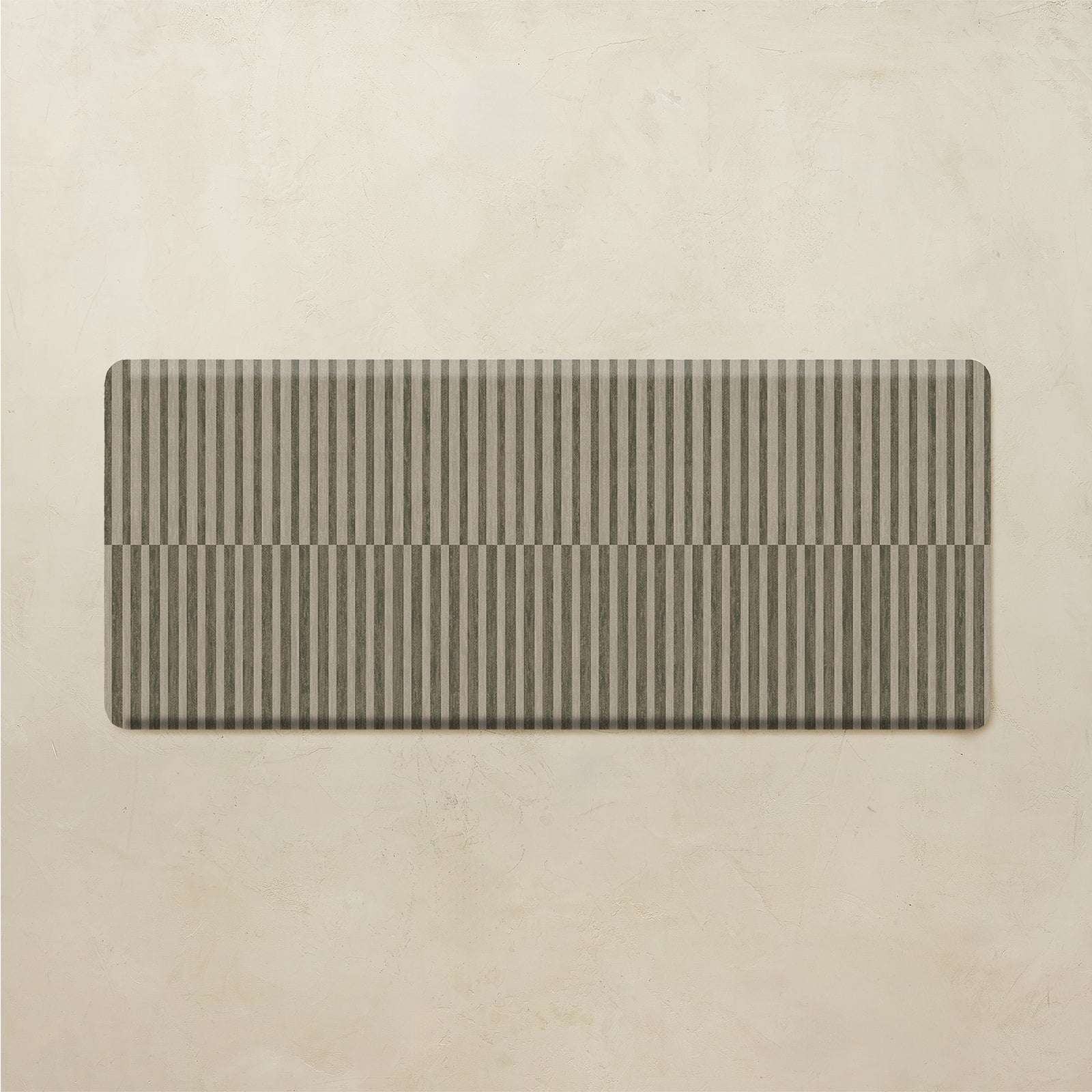 Rectangular striped kitchen mat on a beige background