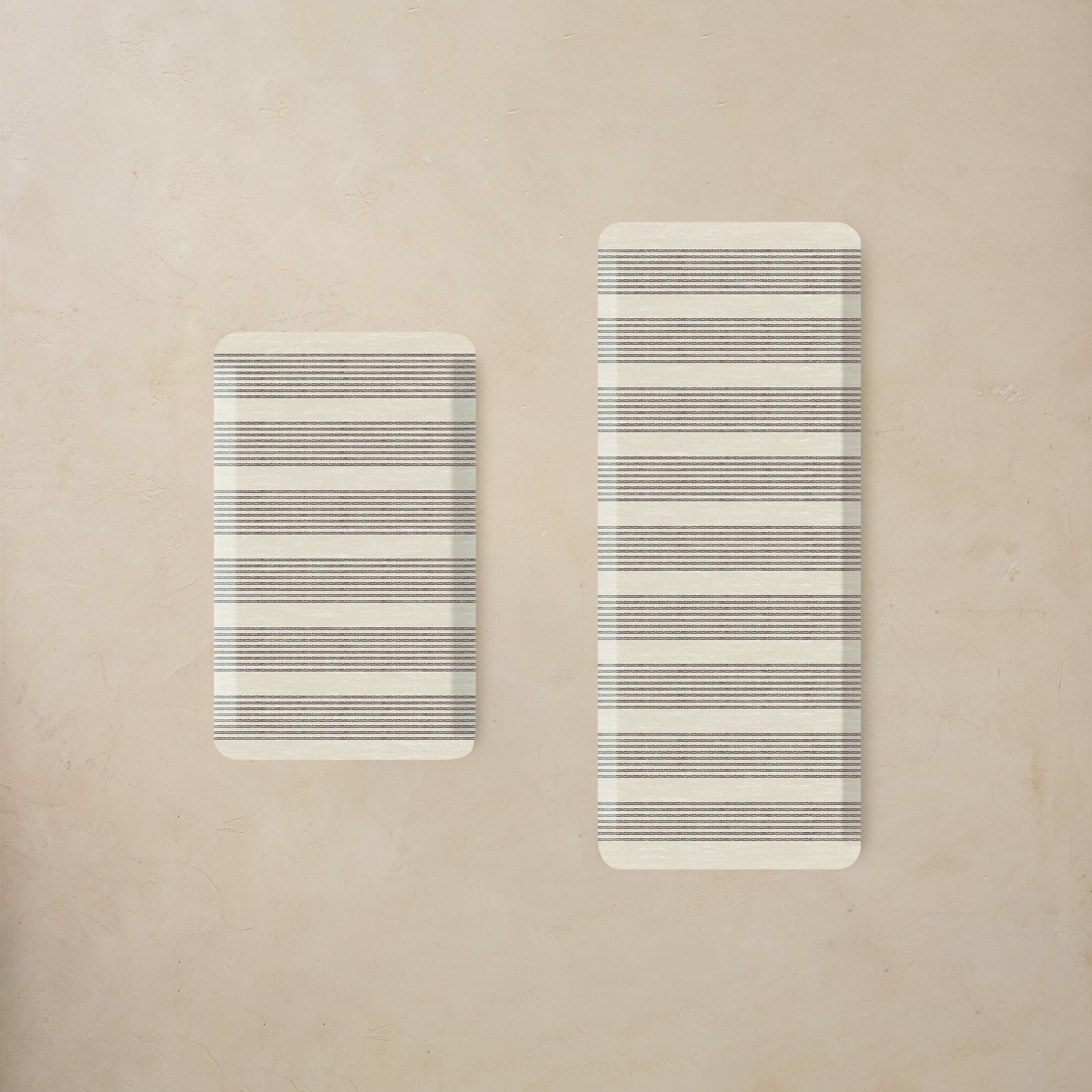 Two rectangular kitchen mats with striped pattern on a beige background