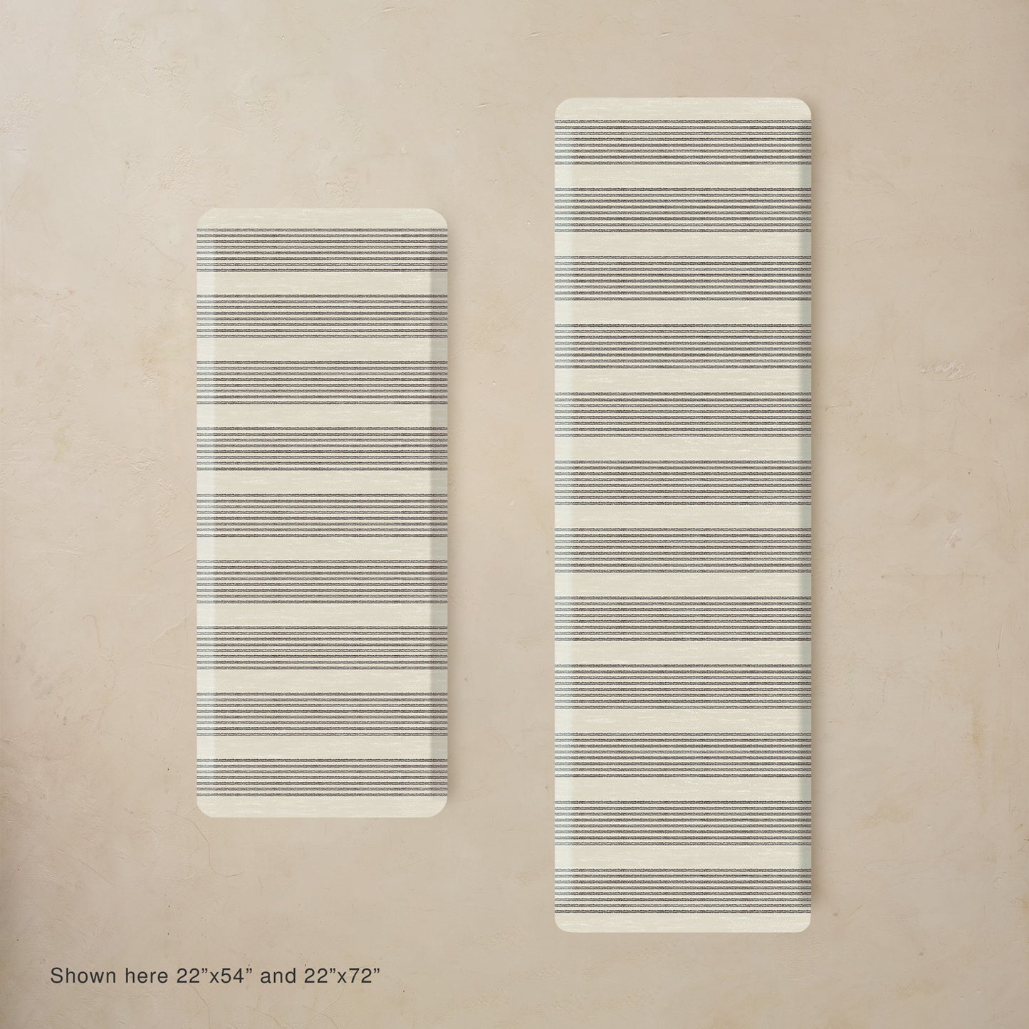 Two black and white striped mats on a beige background