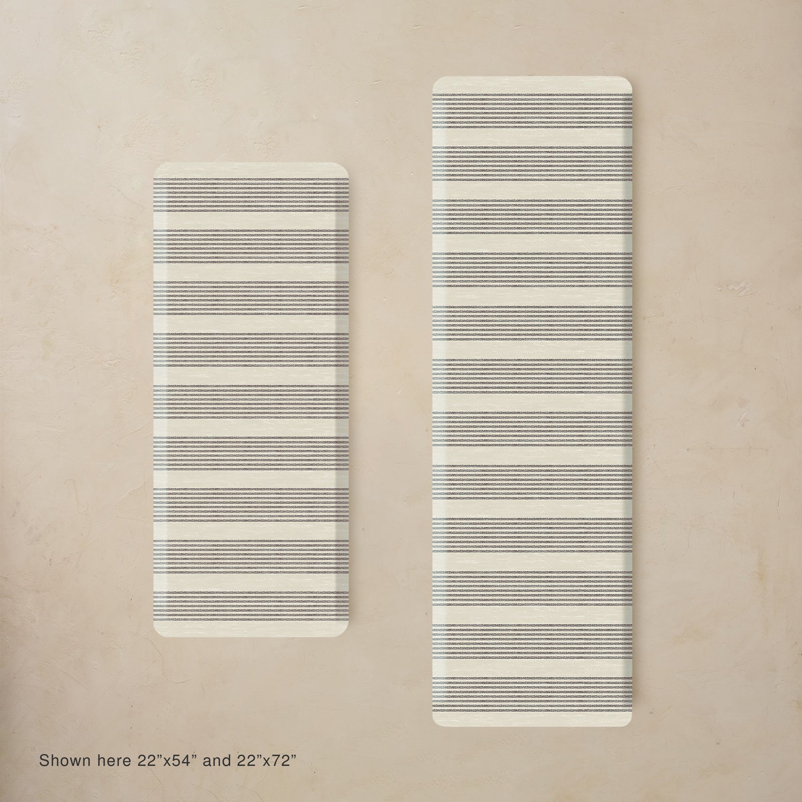 Two black and white striped mats on a beige background
