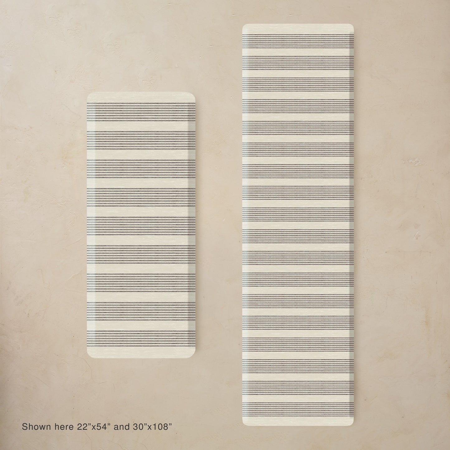 Two black and white striped mats on a beige background