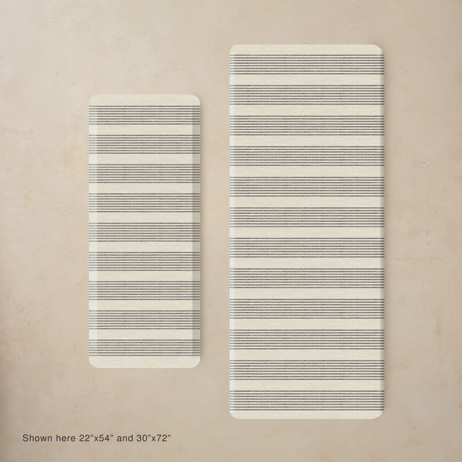 Two black and white striped kitchen mats on a beige background