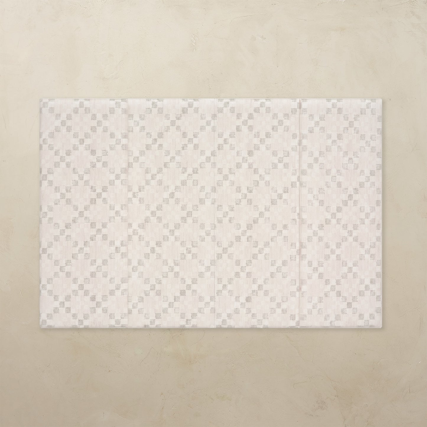 White quilted mat on a beige background