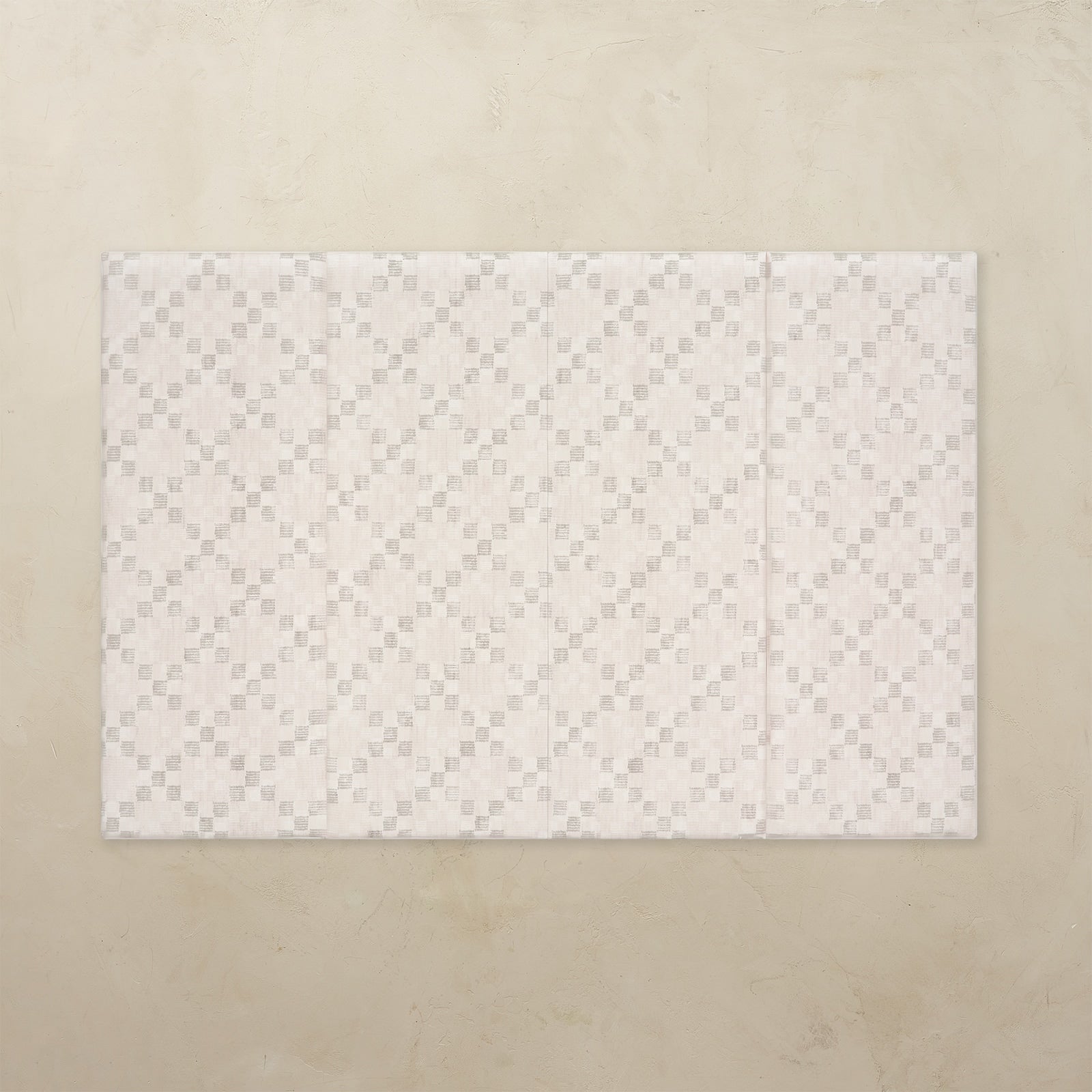 White quilted mat on a beige background