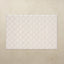 White quilted mat on a beige background