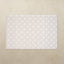 Patterned tumbling mat with blue and white design on a beige background
