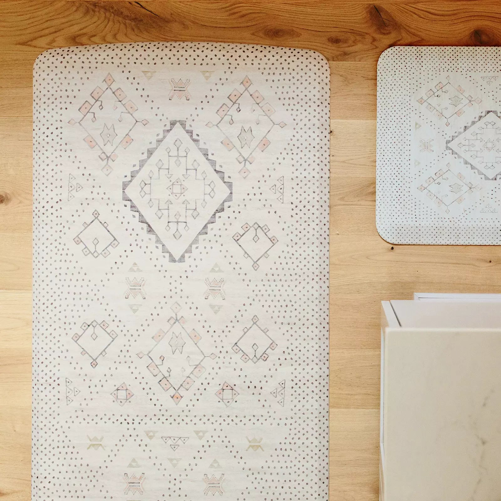 Nama Standing Mat in Ula Oat neutral boho print. Anti-fatigue kitchen mat shown in kitchen from above displaying two sizes of the kitchen mat.