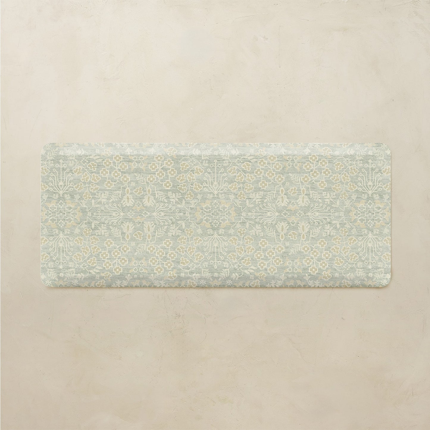 Floral patterned kitchen mat on a beige background