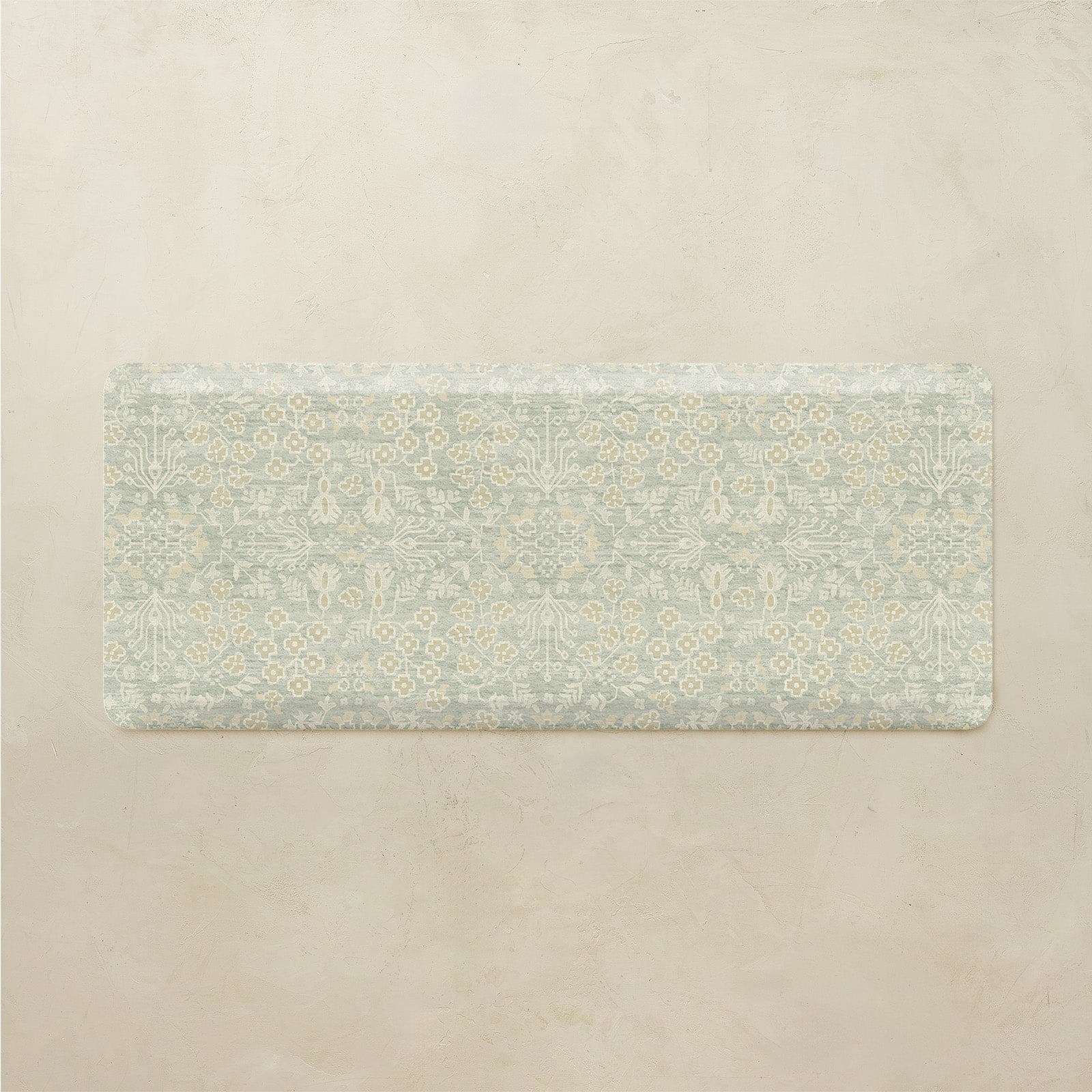Floral patterned kitchen mat on a beige background