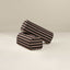 Two striped fabric armrests on a beige background