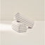 Two cylindrical armrests with striped pattern on a light background