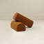 Two cylindrical boucle armrests in chestnut brown color, placed on a white surface.