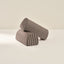 Two cylindrical armrests with striped pattern on a beige background