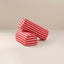 Two cylindrical red and white striped fabric armrests on a light beige studio background.