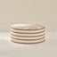 Round woven basket with black stripes on a beige background