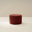 Red textured ottoman on a beige background