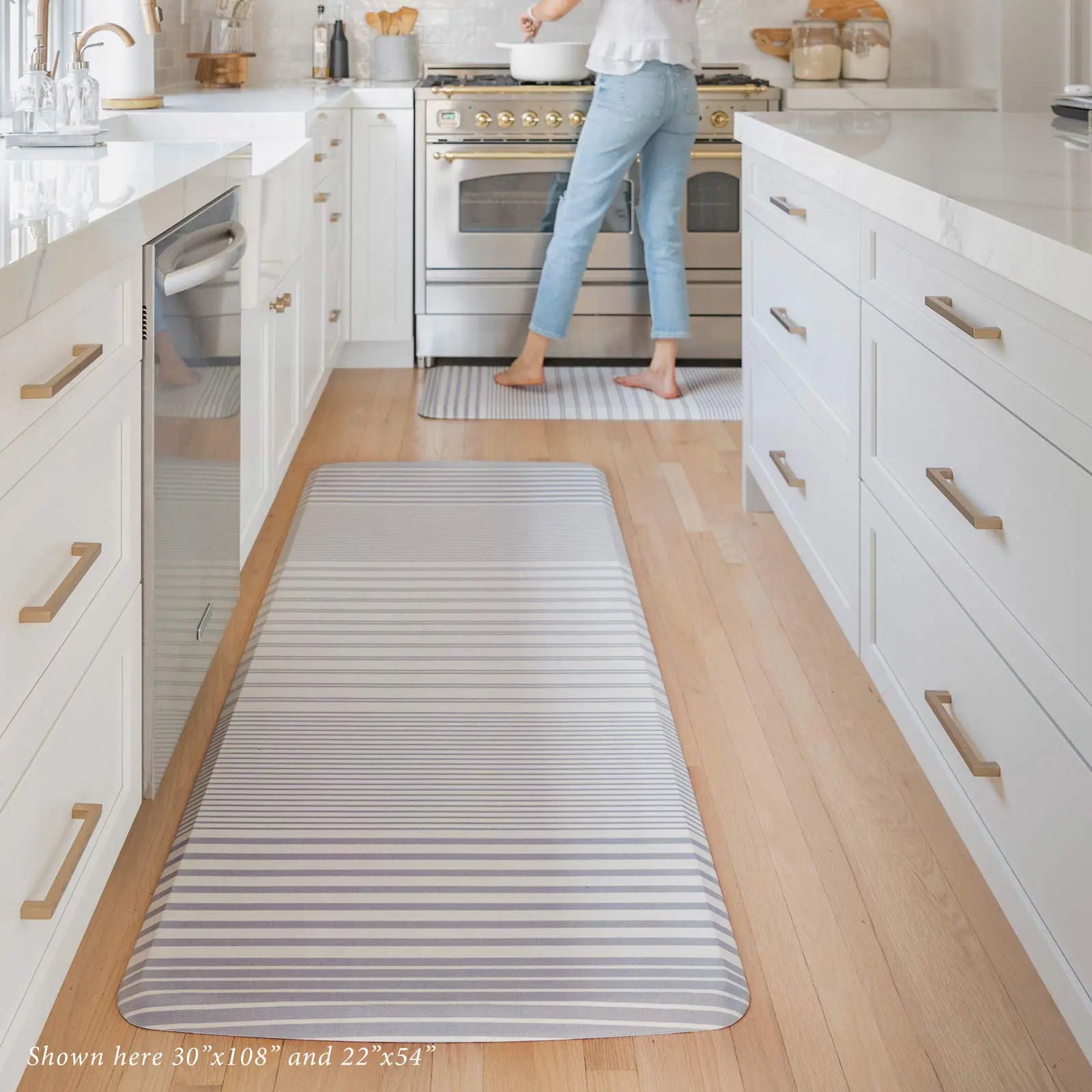 Blue and white minimal stripe kitchen mat in kitchen shown in 30x108 and 22x54 sizes.