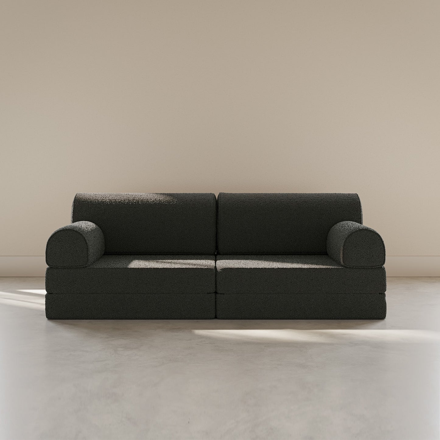 Dark blue sofa on a light beige floor with a neutral wall background