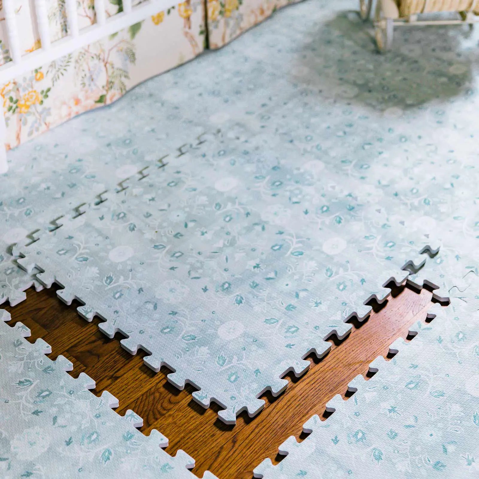 Powder blue floral pattern play mat shown with one tile removed