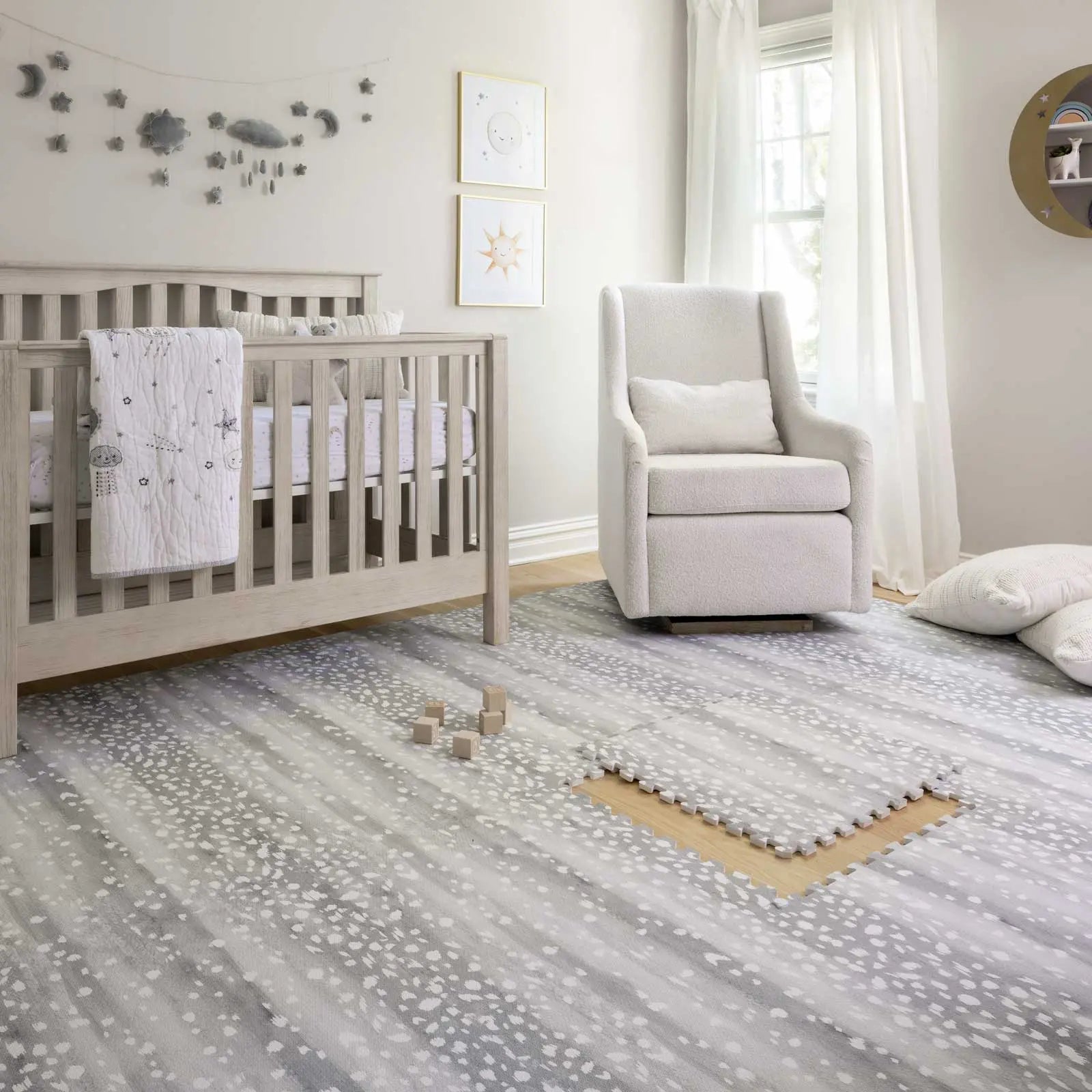 Fawn silver gray animal print play mat shown in nursery with one tile exposed