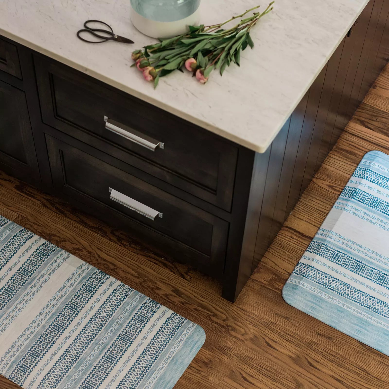 Paloma blue and white boho stripe kitchen mat shown from above in kitchen in sizes 20x72 and 20x32