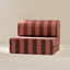 Striped play couch with red and brown pattern on a beige background