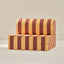 Striped play couch chair with brown and yellow pattern on a beige background