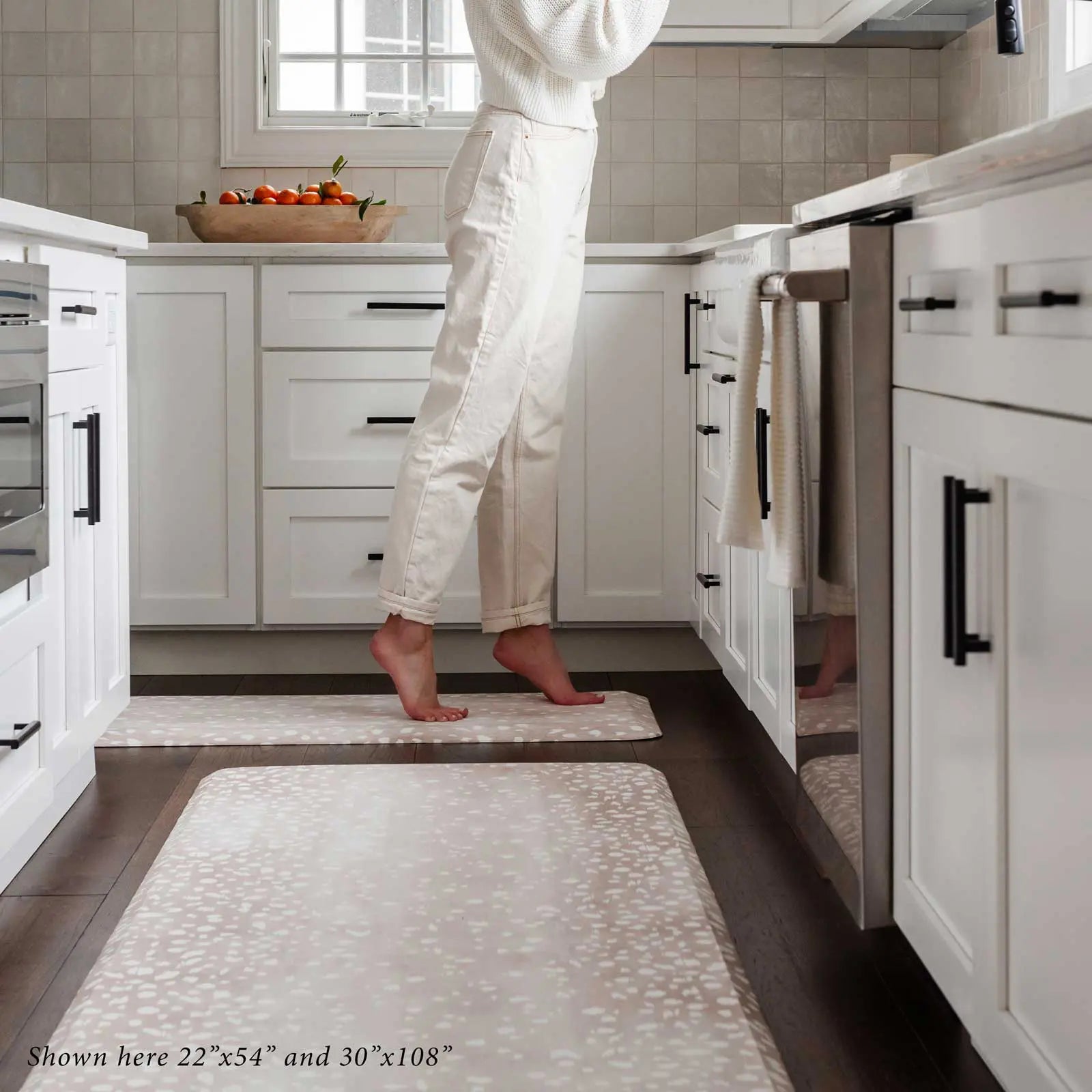 Fawn brown neutral animal print standing mat shown in kitchen with woman standing at the counter in sizes 22x54 and 30x108