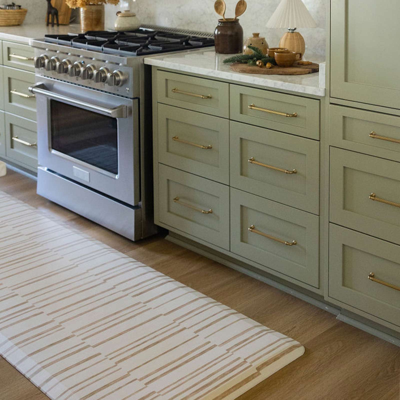 Nara natural beige and cream inverted stripe standing mat shown in kitchen in front of counter in size 30x108