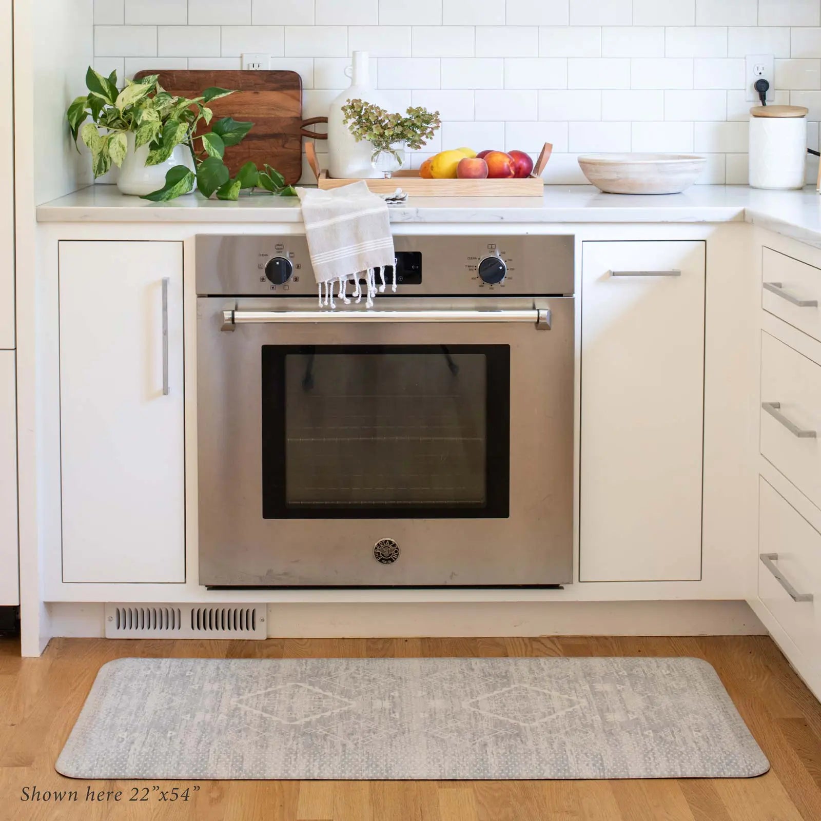 Ula gray and white Minimal Boho Pattern Standing Mat shown in kitchen in front of oven, shown in size 22x54