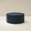Blue striped ottoman on a beige background