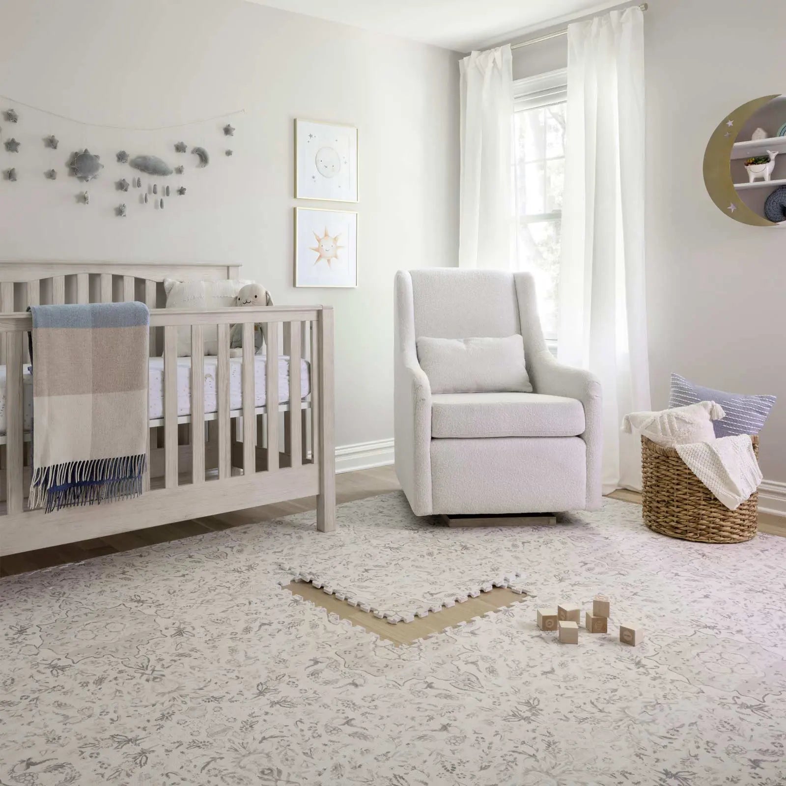 Emile latte neutral floral play mat shown in nursery with one middle tile lifted and exposed and wooden blocks on the mat
