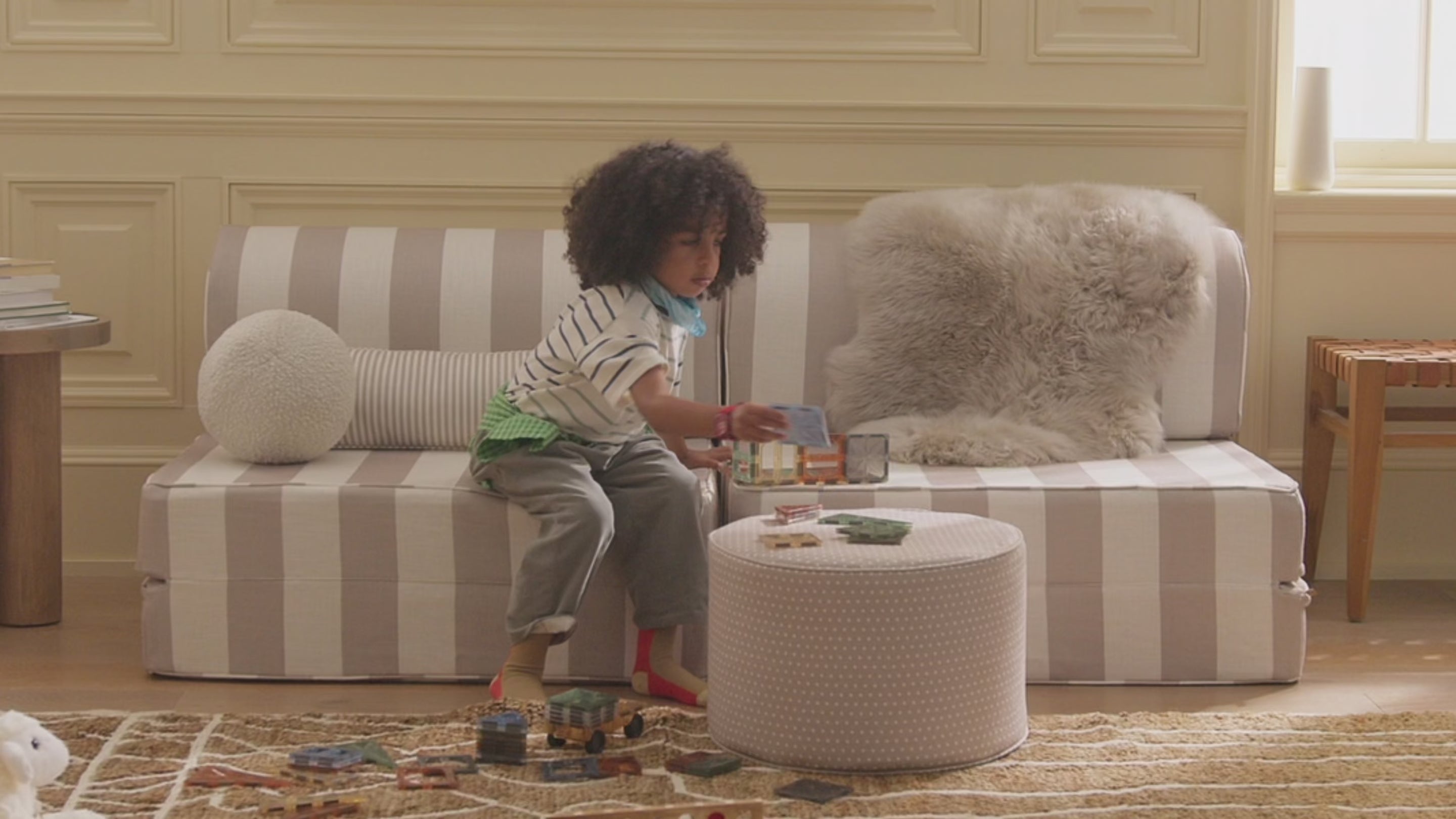 Video showing children in different playrooms enjoying toys and soft furniture made into forts 