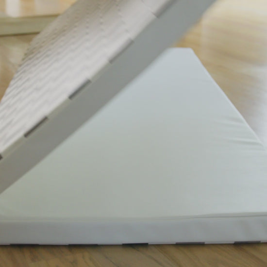Video of Tuxedo black and white checker print tumbling mat being shown in rooms, toddler jumping on the mat, and being folded and put into the closet
