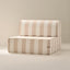 A striped chair with a white and beige color scheme, on a plain background.