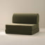 A green upholstered play couch with a beige background