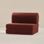A dark red play couch on a beige background