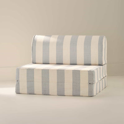 Striped play sofa with blue and white stripes on a beige background