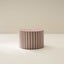 A cylindrical striped ottoman in a neutral color placed on a plain background.