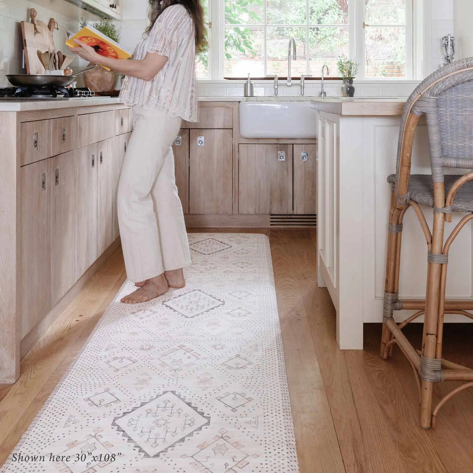 Neutral boho kitchen mat with woman cooking in kitchen on size 30x108