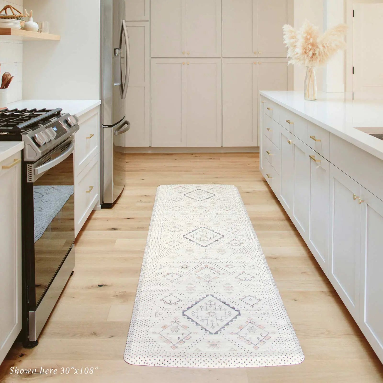 Neutral boho kitchen mat in between two kitchen counters in size 30x108