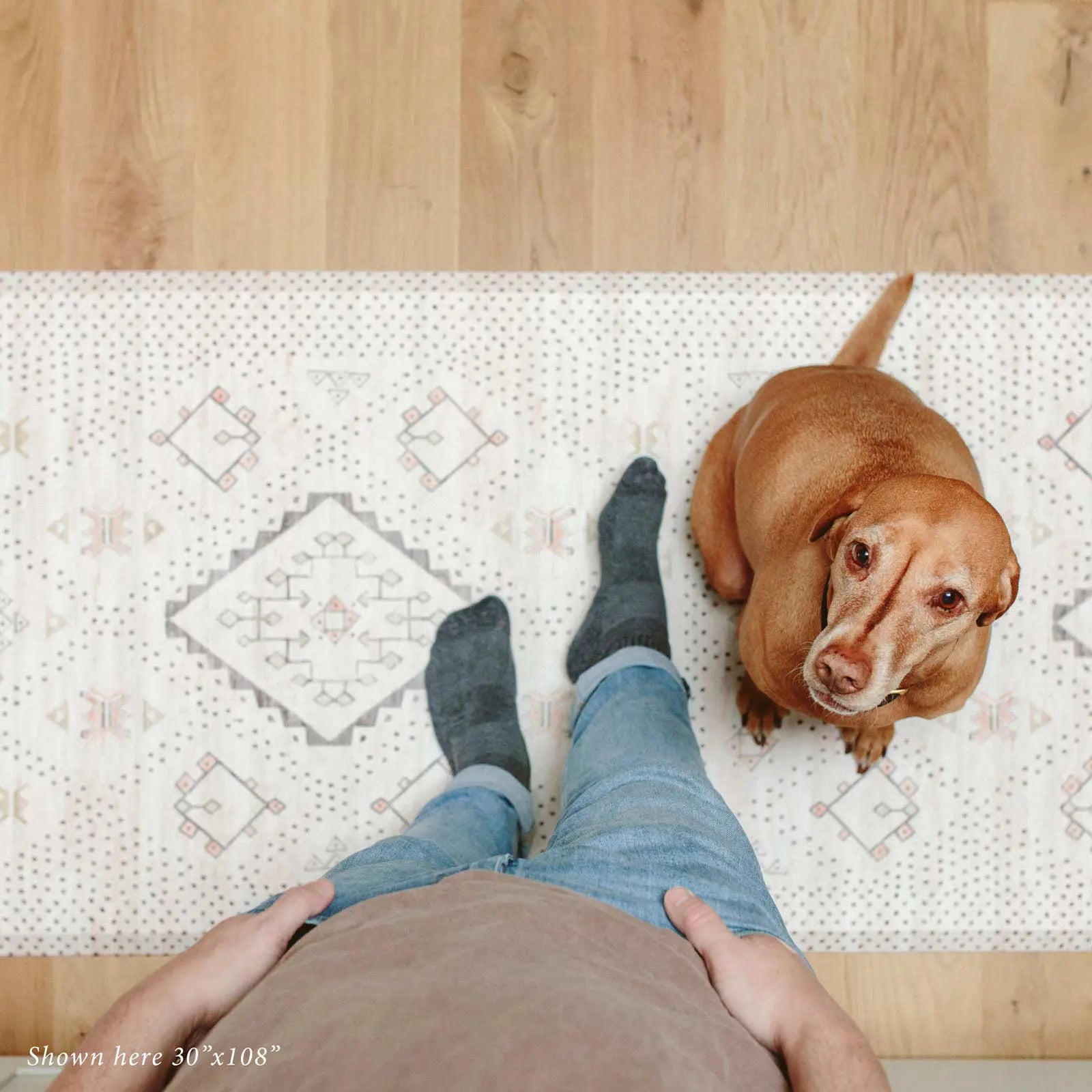 Neutral boho kitchen mat with man and dog shown in size 30x108