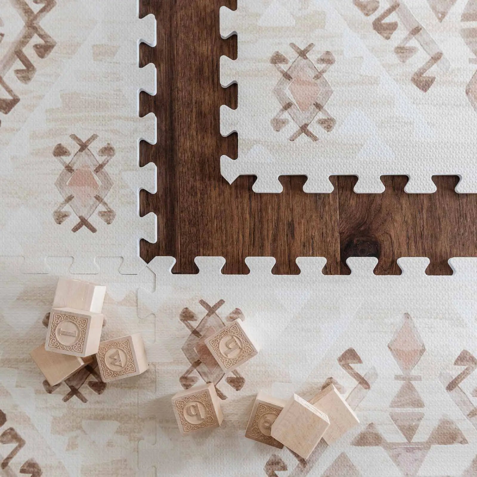 Nalla Mojave neutral beige brown and pink boho print play mat close up shot of the pattern and one tile exposed with wooden blocks on the mat
