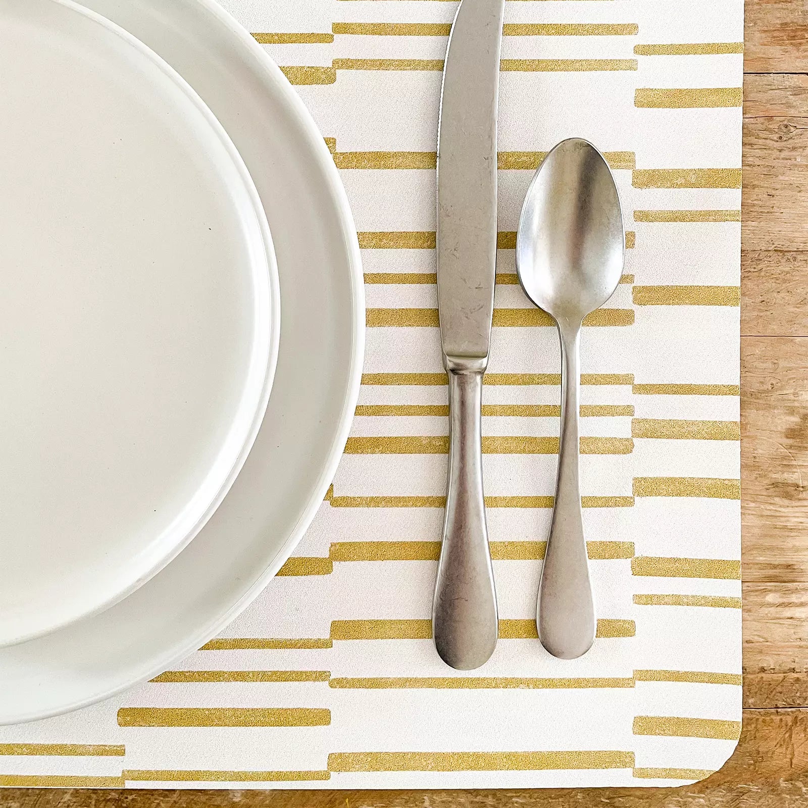 Nara Ochre Yellow Striped place mat up close with plate and silverware